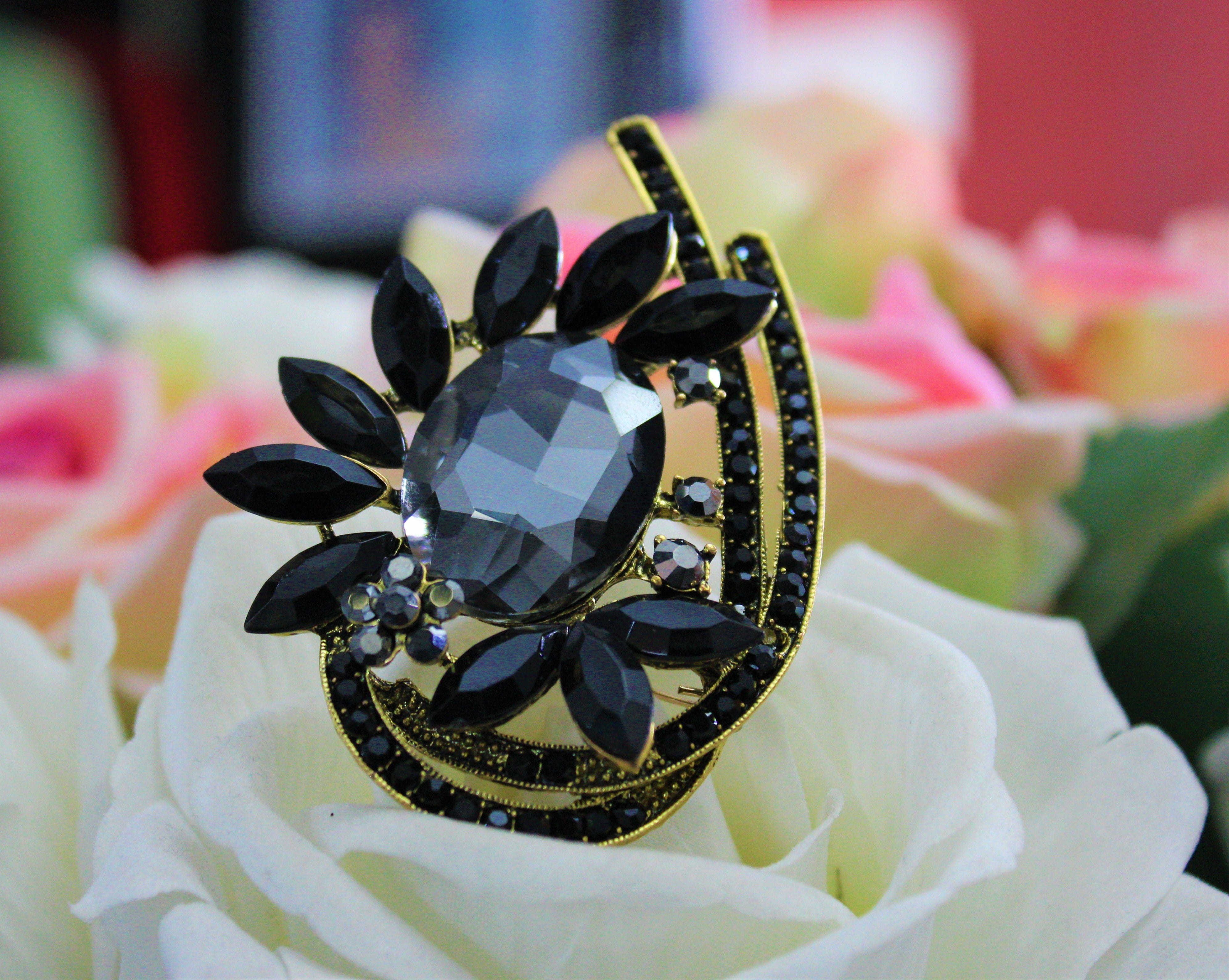 Gold black brooch